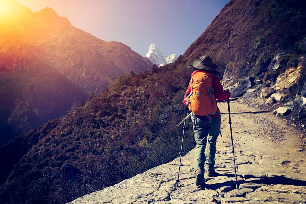 young woman backpacker trekking at the himalaya mountains